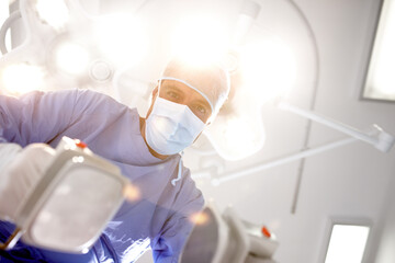 A light at the end of the tunnel. Patients view of a doctor trying to resuscitate himher with a...