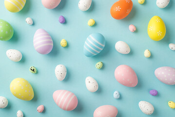 Fototapeta na wymiar Top view photo of easter decorations multicolored easter eggs on isolated pastel blue background