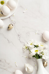 Top vertical view photo of the bouquet of chrysanthemums few eggs plate and ceramic rabbit on isolated marble background copyspace