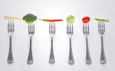 Mouthful of goodness. A series of forks with healthy mouthfuls of vegetables on them.