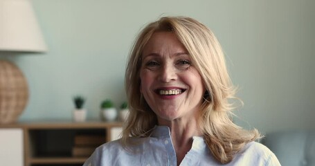 Head shot portrait 55s attractive blond woman pose looks at camera, having wide toothy smile advertise dental services clinic for older citizen. Carefree retired life, medical insurance cover concept