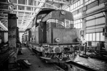 Old diesel locomotive standing in the depo. Black and white picture