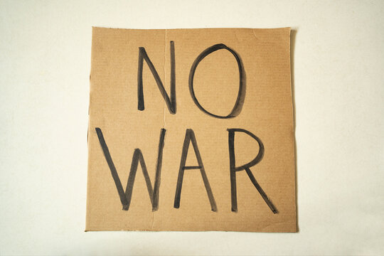 "No War" written on a cardboard