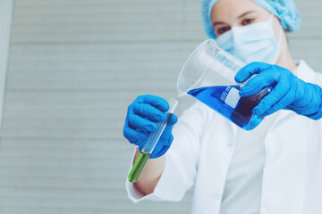 Scientist in uniform holding beaker and test tube have chemical liquid for testing chemical...
