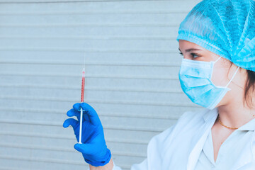 Scientist in uniform holding beaker and test tube have chemical liquid for testing chemical reaction.