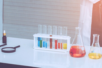 Beaker and test tube have chemical liquid for testing chemical reaction.