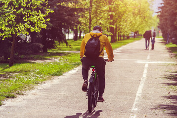 Naklejka premium Cyclist ride on the bike path in the city Park 