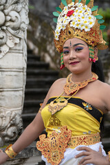 Asia women wearing traditional balinese dance costume in Bali temple.