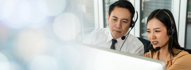Business team wearing headset working actively in office . Call center, telemarketing, customer...