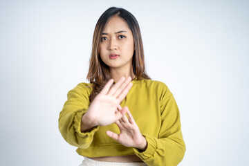Young asian woman refusing with both palms gesture