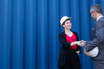 Smart creative logistics manager and Shipping engineer woman discussion, talking and check up control loading containers box from cargo freight ship for import export.  Logistics worldwide connect.