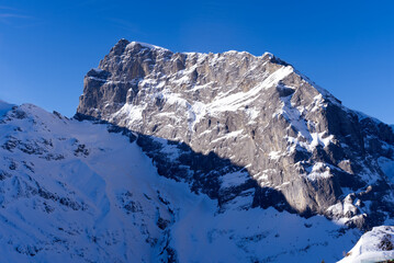 Fototapeta na wymiar Famous Mount Titlis 3,238 meters above sea level at ski resort Engelberg in the Swiss Alps on a sunny winter day. Photo taken February 9th, 2022, Engelberg, Switzerland.
