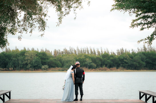 A loving couple, bride and groom hugging on the lake.