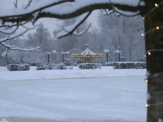 Children's carousel with lights in the distance