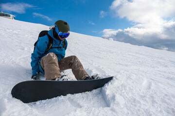 Man in the mountains with a snowboard