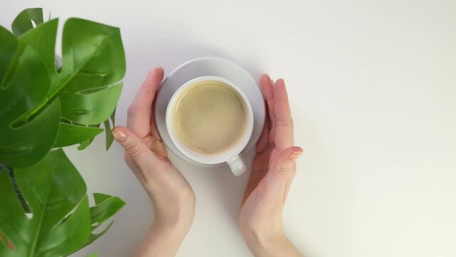 Top view put coffee couple on white table with green plant in restaurant. Breakfast at home mug of hot espresso. Morning with americano. Bring a cup of black drink or tea. Put on table in office.