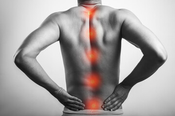 male shirtless body pain on spinal cord anatomy with red mark on spine