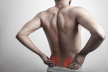 fitness man touching his lower back pain zone