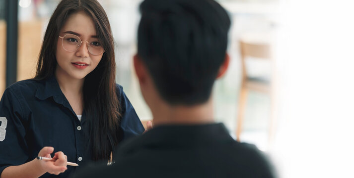 Young attractive asian woman with glasses during job interview