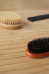 Bath massage brushes on wooden background. Aesthetic spa setting