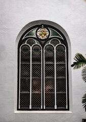 a vintage window with a few leaves on the side
