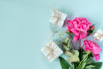 Bouquet of beautiful pink peonies with gift boxes in paper wrapping. Banner for congratulations or invitation.