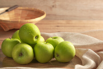 Group of fresh Green Apple on wooden board background. Healthy fruits concept.