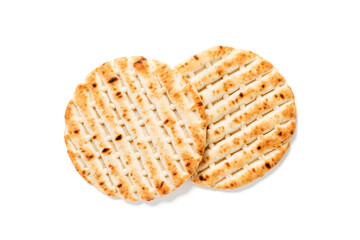 Fresh baked greek pita bread isolated on white background. top view
