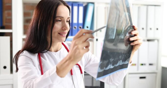 Woman doctor examining x-ray in clinic closeup