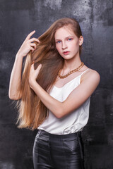 Fototapeta na wymiar Fashion portrait of a young beautiful blonde girl