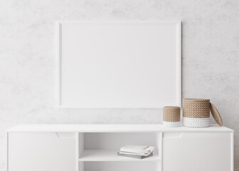Empty horizontal picture frame on white wall in modern living room. Mock up interior in minimalist, scandinavian style. Free, copy space for picture. Console, rattan basket. 3D rendering.