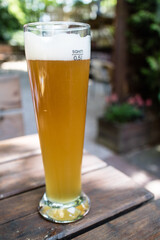 Tall glass of beer on empty table