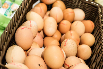 Basket full of marked brown eggs