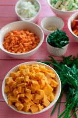 Pumpkin and carrots diced, fresh sweet vegetables, bright orange color, beauty of nature products, raw ingredients for cooking in the kitchen