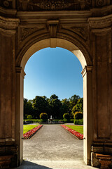 Fototapeta premium Arched doorway leading to a formal garden