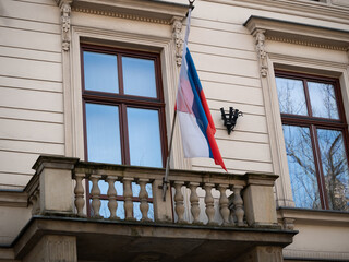 Russian national flag fluttering on a pole on the wall of Krakow Consulate General of Russia or...