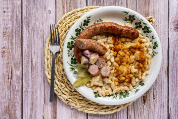 butifarra with beans, Botifarra amb mongetes or Botifarra amb seques, is a traditional dish of Catalan cuisine, based on butifarra and white beans.