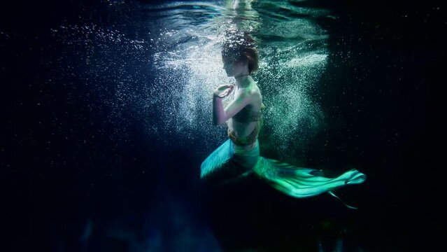 fantastic underwater shot with fairytale mermaid, mysterious and magical world inside ocean