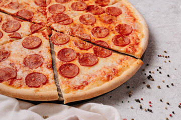 Pepperoni pizza with salami on a light background