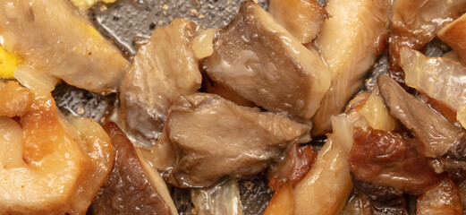 Fried mushrooms with onions in a pan.