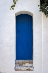 Fototapeta na wymiar Beautiful blue door and white wall in Sitges, Spain.