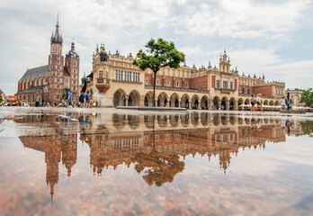 Krakow, Poland - frequent rainshowers make Old Town Krakow look like a mirror when it's full wet. Here in particular Market Square, a main landmark 
