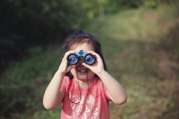 Little girl using binoculars