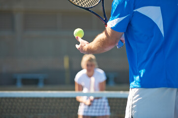 You ready for this. Cropped image of a man bouncing a tennis ball in his hand before a service.