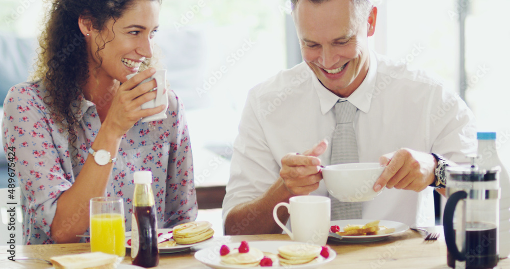 Wall mural Happiness happens at the breakfast table. Shot of a happy middle aged couple having breakfast together in the morning at home.