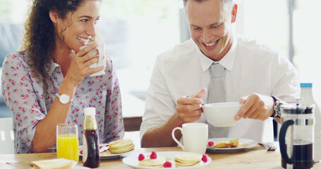 Happiness happens at the breakfast table. Shot of a happy middle aged couple having breakfast together in the morning at home.
