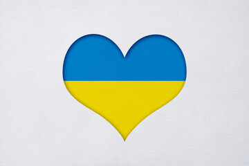 Paper cut Ukraine flag in the shape of the heart with copy space