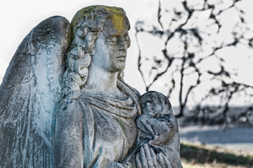 Fototapeta na wymiar Angel of death with a baby in her arms (Azrael, Azriel, Malak al-maut, concept of children's death)