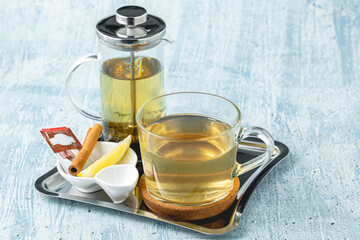 Hot winter tea served with a french press on a wooden table