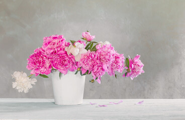 bouquet of pink and white peonies  on background old wall